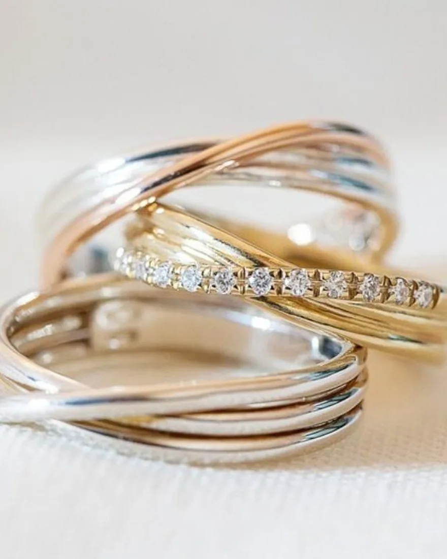 Tris di anelli multifilo in oro giallo, oro rosa e argento, con un filo di diamanti al centro